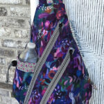 Purple floral sling bag with water bottle