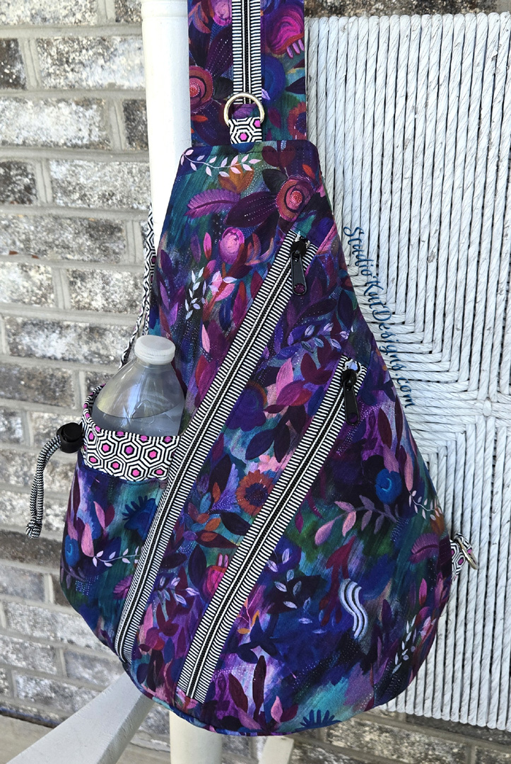 Purple floral sling bag with water bottle