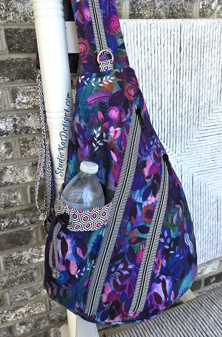 Purple floral sling bag with water bottle
