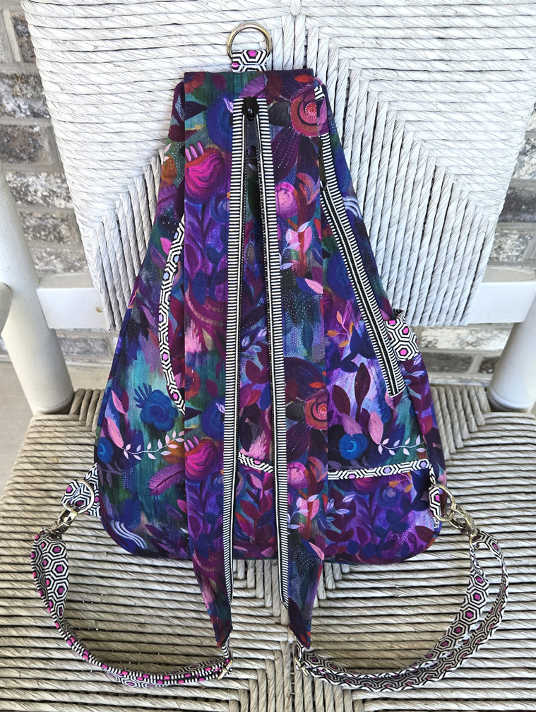 Purple floral patterned backpack with decorative straps