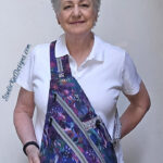 Smiling woman with purple patterned crossbody bag