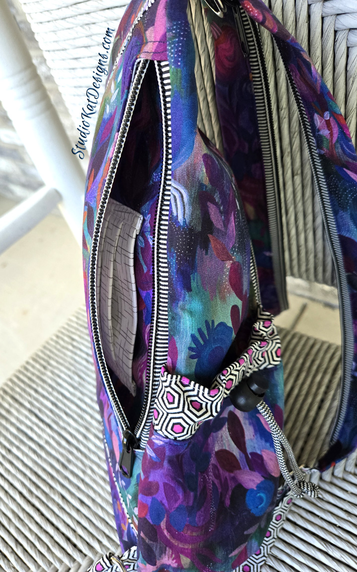 Purple floral zippered sling bag with notebook