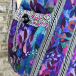 colorful floral fabric bag with striped zipper