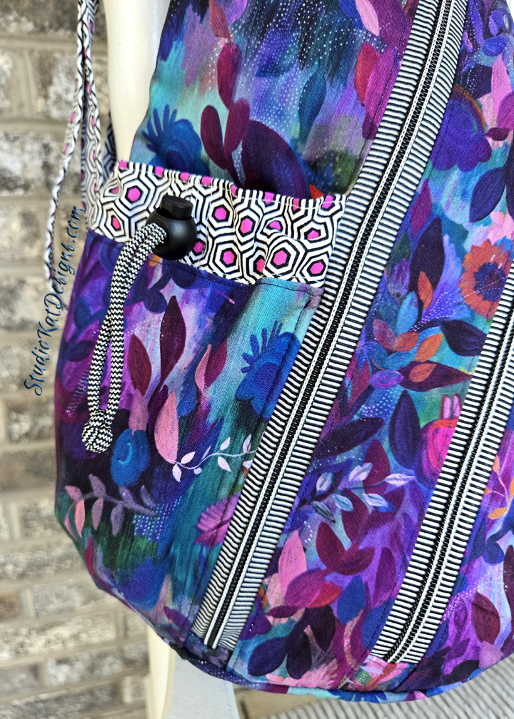 colorful floral fabric bag with striped zipper