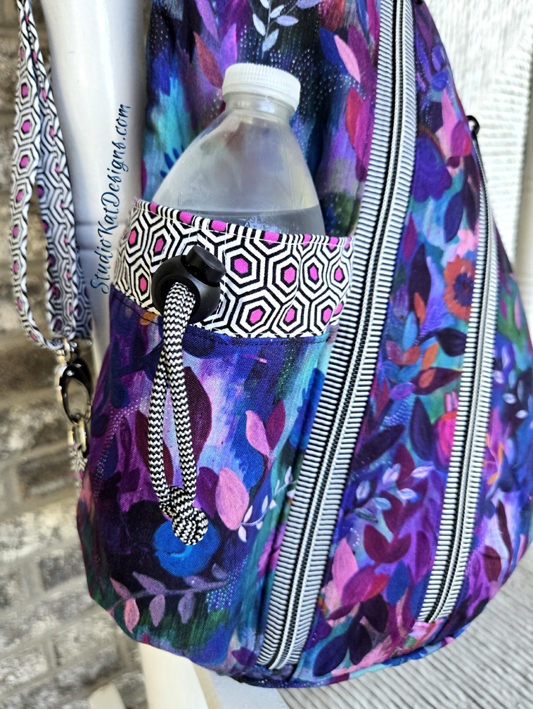 Purple floral-patterned backpack with water bottle